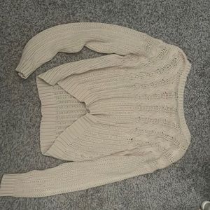 cream sweater cropped in the fron